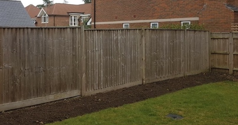 Before image of a garden in Ferndown showing empty borders